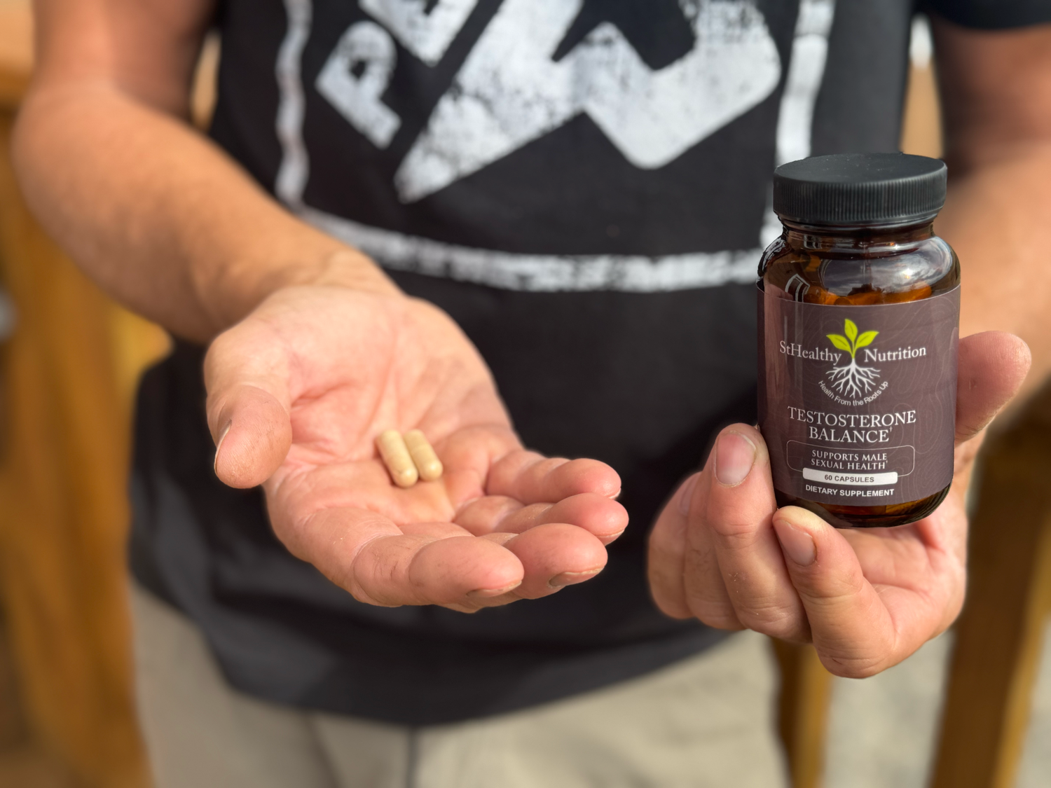 Person holding a bottle of supplements and pills in their hands.